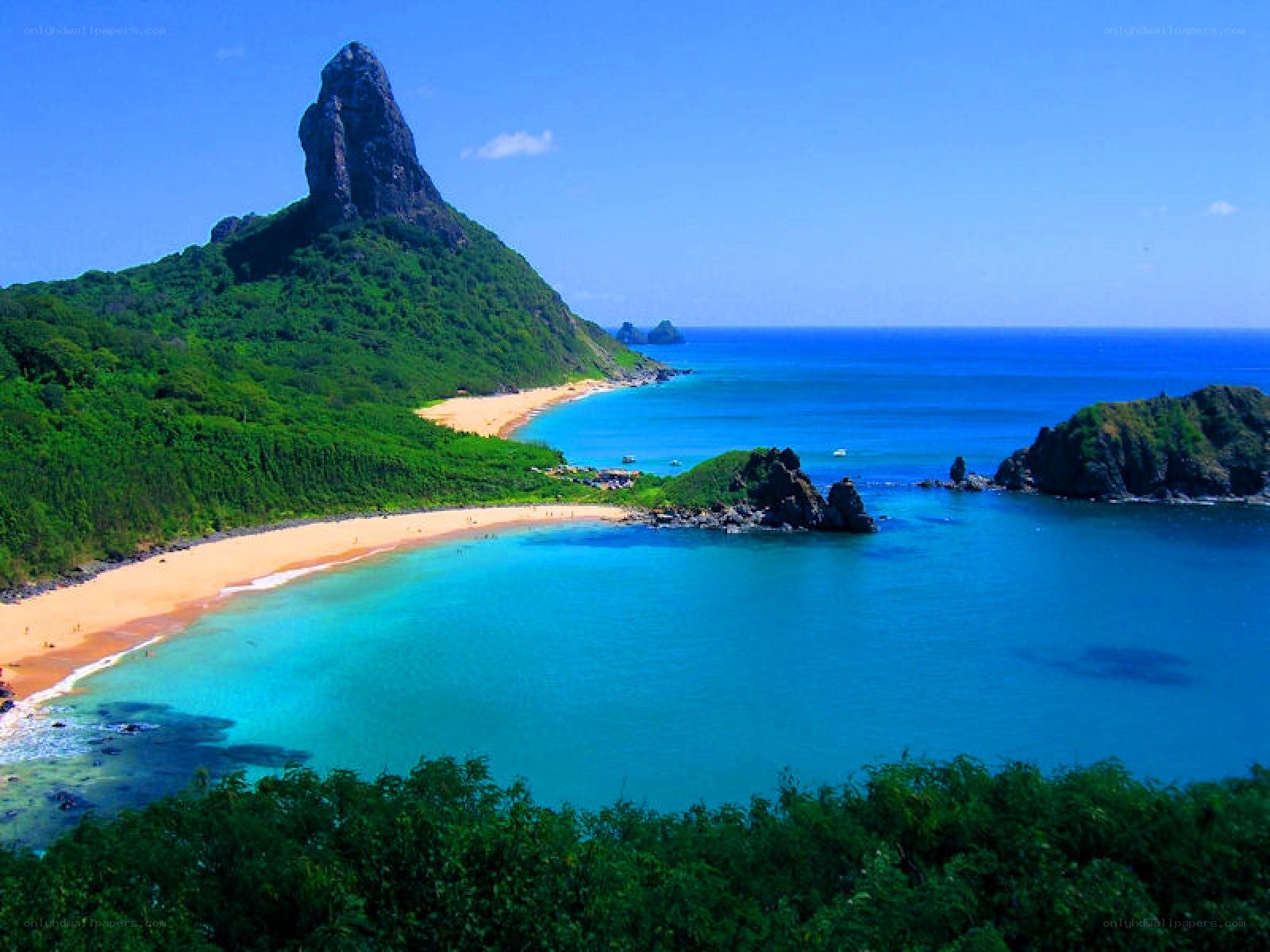 tropical beach with rocky peak