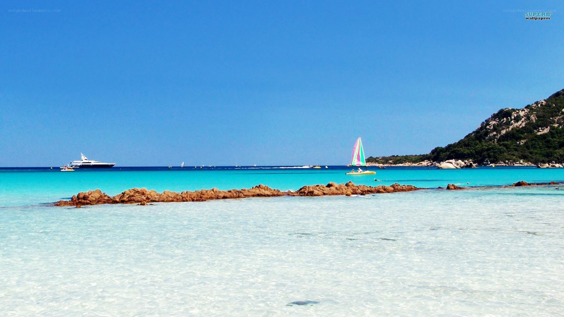 tropical beach with sailboat