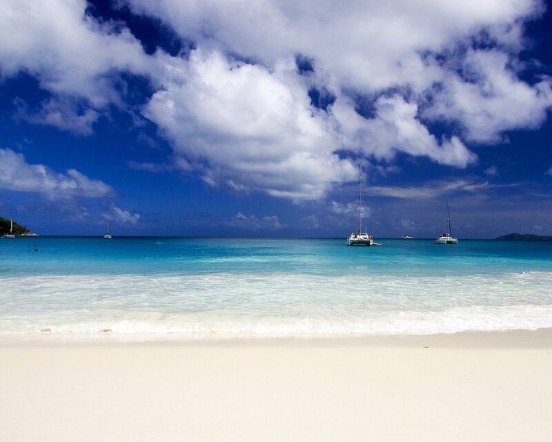 tropical beach with sailboats