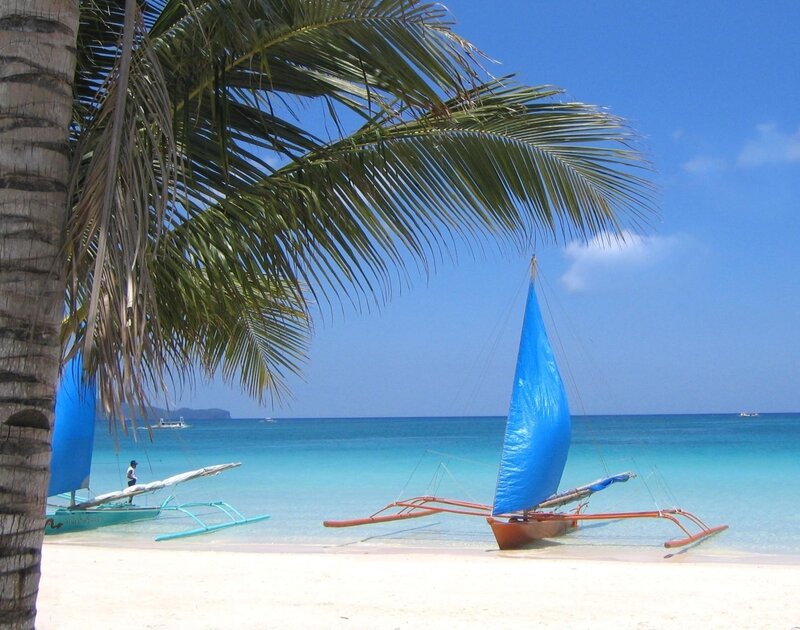 Tropical beach with sailboats