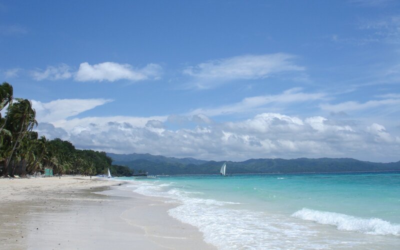 tropical beach with sailboats