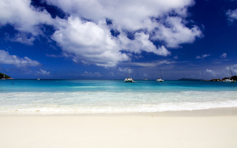 tropical beach with sailboats
