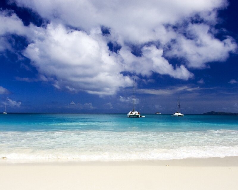 Tropical beach with sailboats