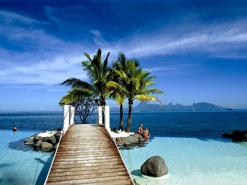 Tropical beach with wooden pier