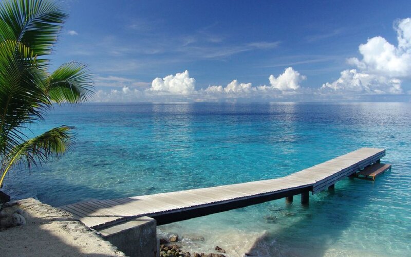 tropical beach with wooden pier