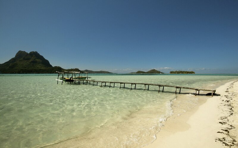 tropical beach with wooden pier