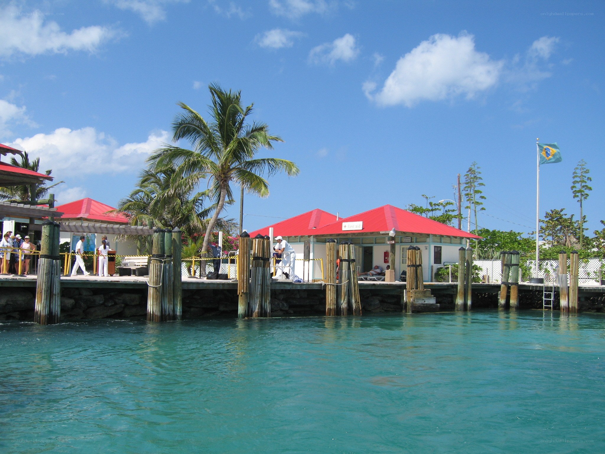 tropical dock with red-roofed buildings