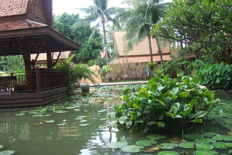 tropical garden with pond and pavilion