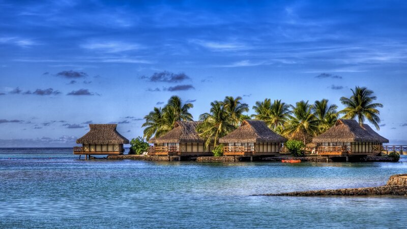 Tropical island bungalows at dusk