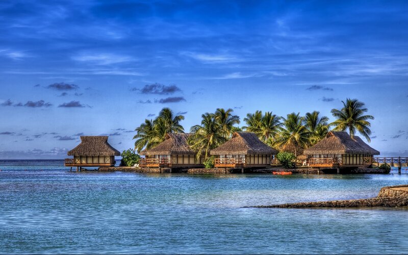 Tropical island bungalows at dusk