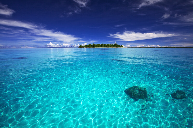 Tropical Island in Ocean — Blue, Serene, Afternoon, Photograph, Sky, Clouds, Reef