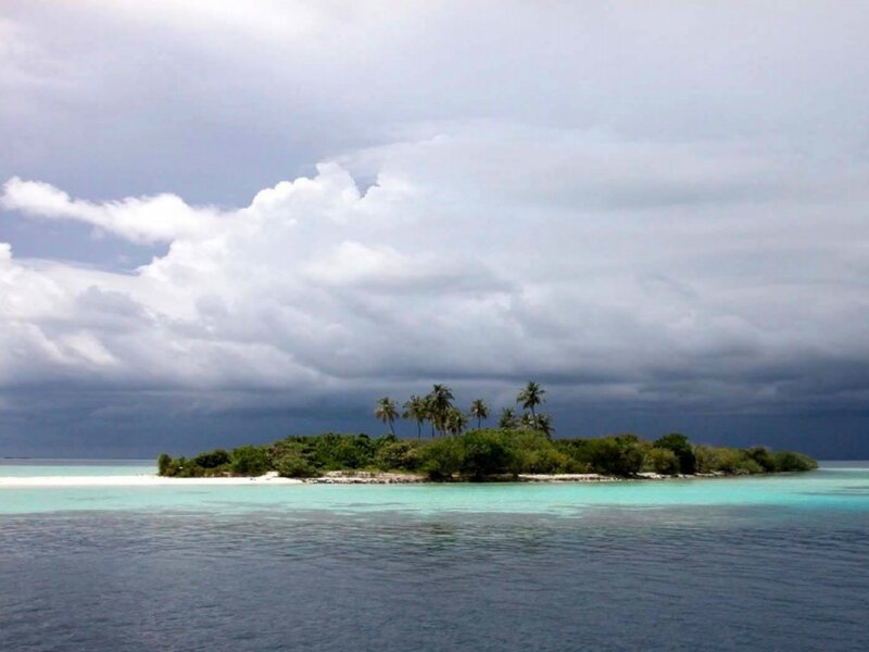 Tropical island under stormy sky