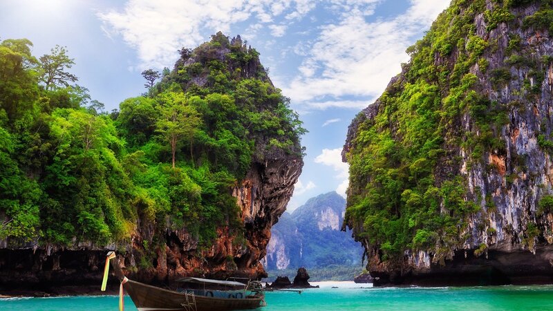tropical island with longtail boat