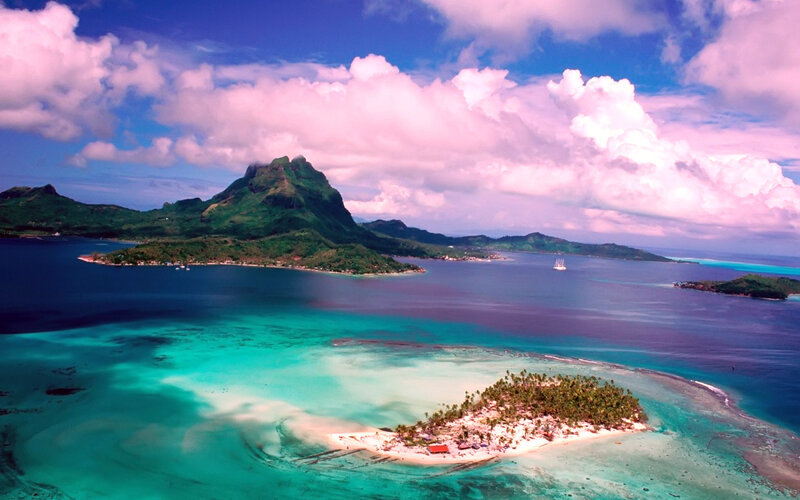 Tropical Island with Mountain — Blue, Serene, Afternoon, Photograph, Ocean, Sailboat, Coral Reef, Green, White