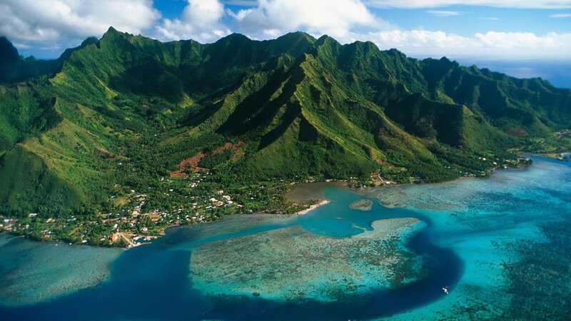 tropical island with mountains and coral reef