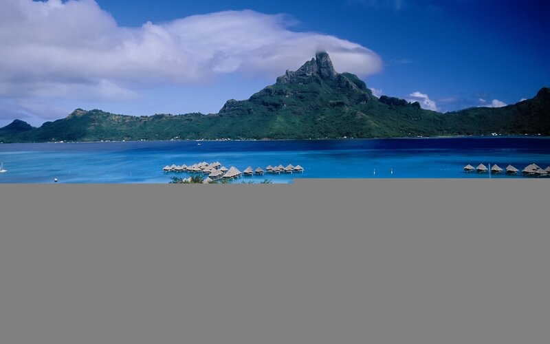 tropical island with overwater bungalows