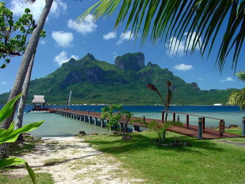 Tropical island with pier and mountains