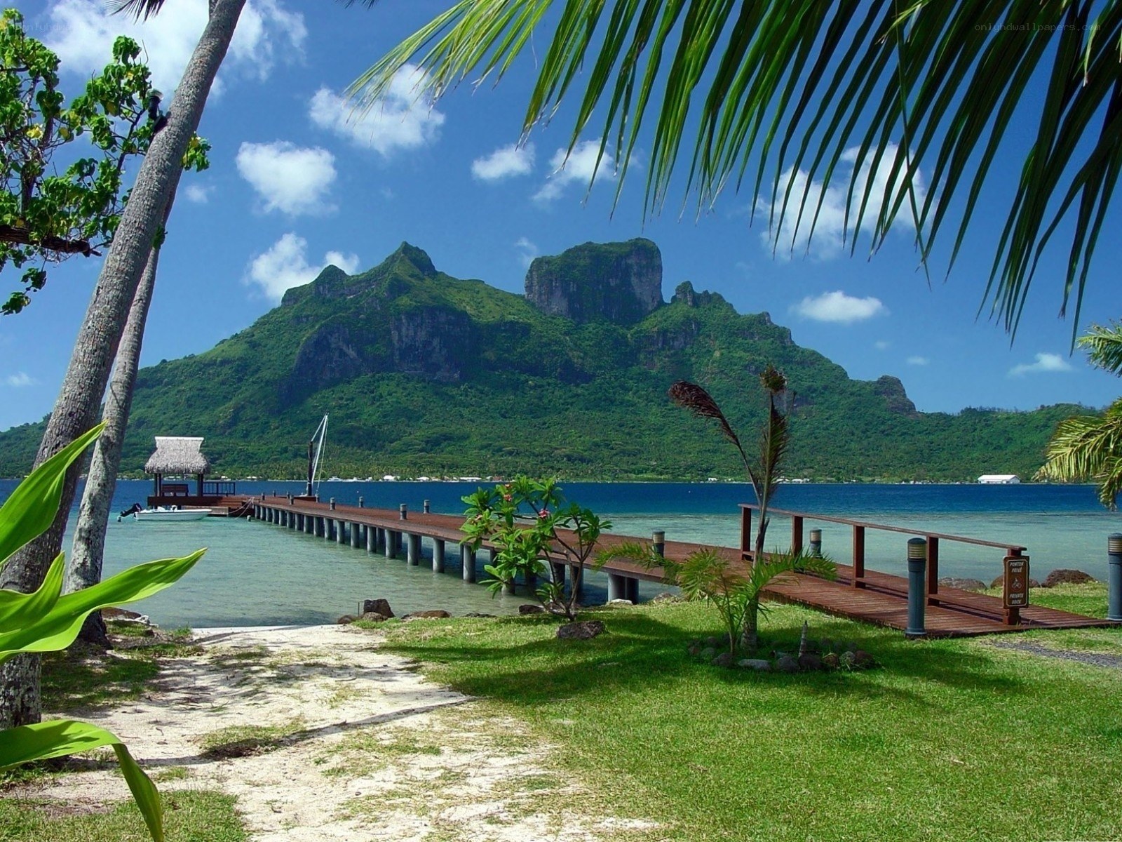 Tropical island with pier and mountains