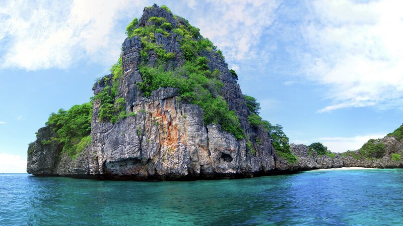 tropical island with rocky cliff