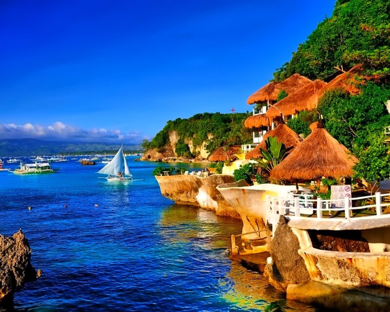 Tropical island with sailboat