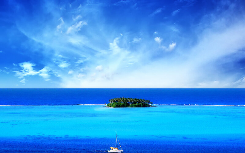 Tropical island with sailboat