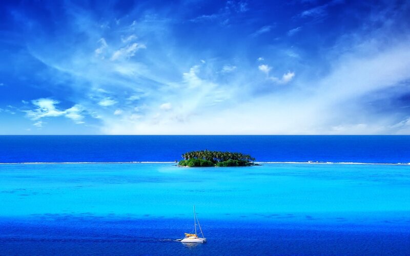Tropical island with sailboat