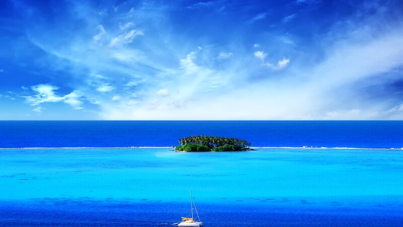 Tropical island with sailboat
