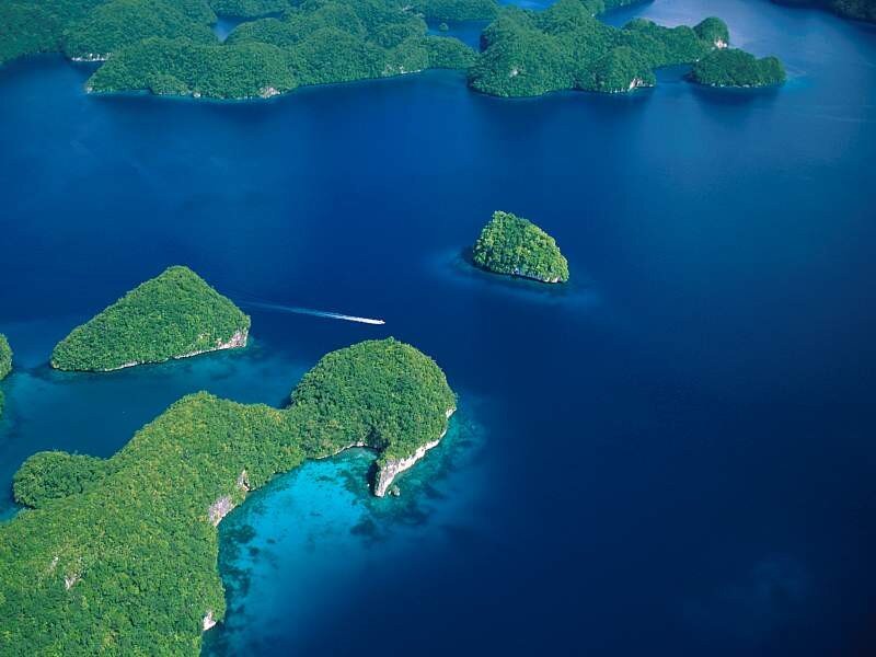 Tropical Islands in Blue Water — Serene, Afternoon, Photograph, Boat