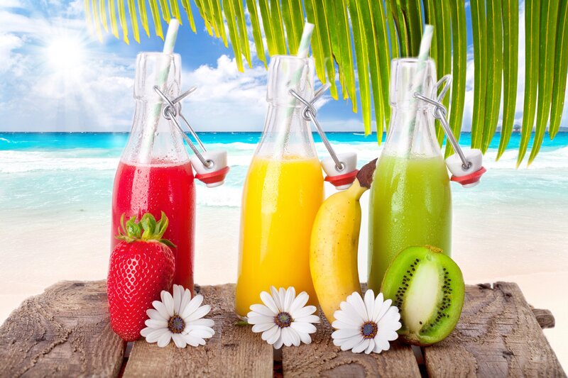 tropical juice bottles on beach