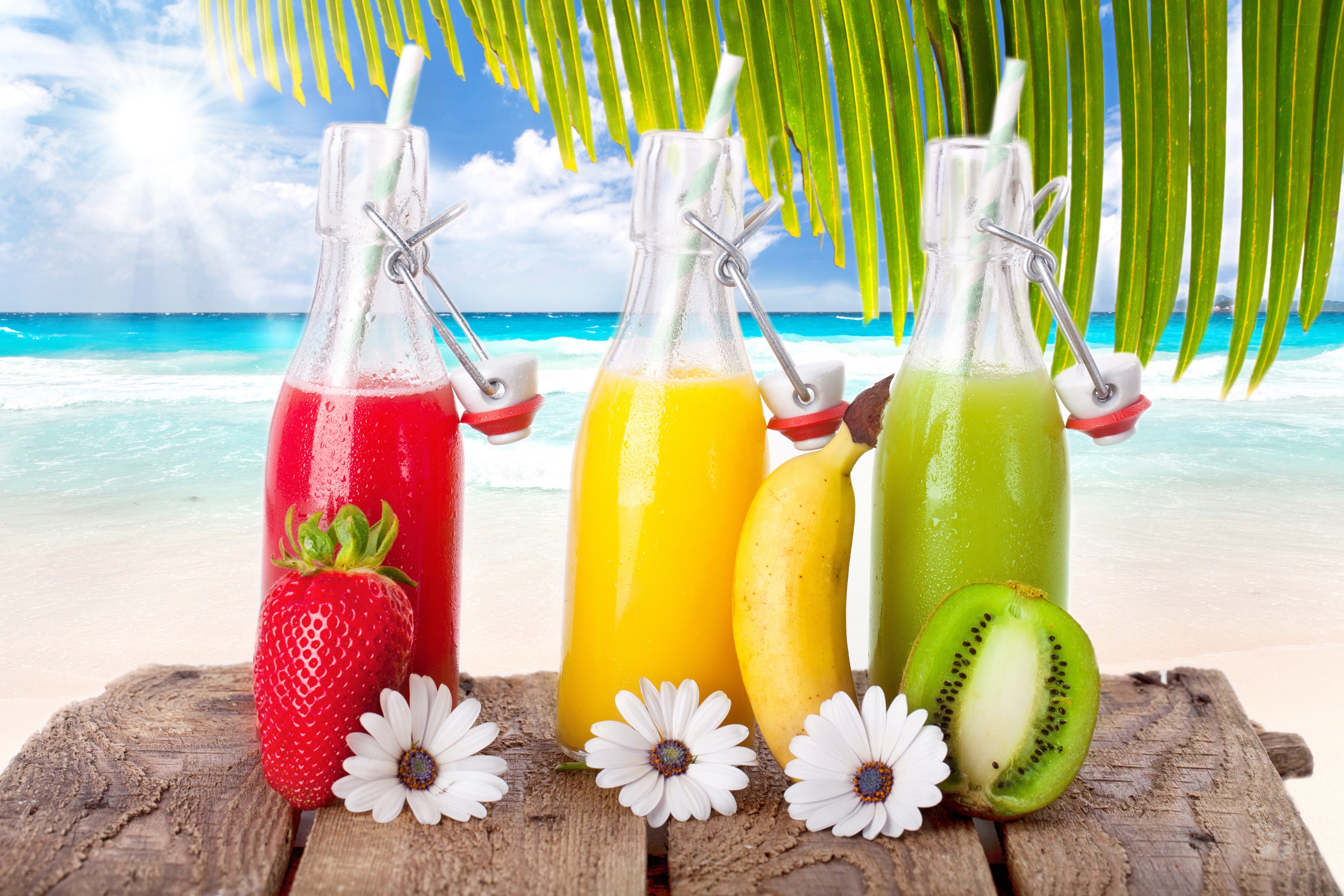 tropical juice bottles on beach