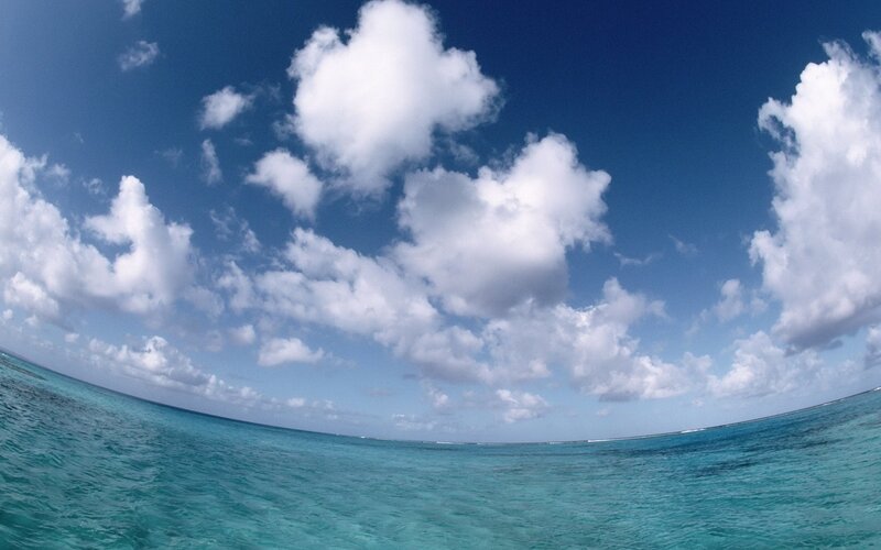 tropical ocean under cloudy sky
