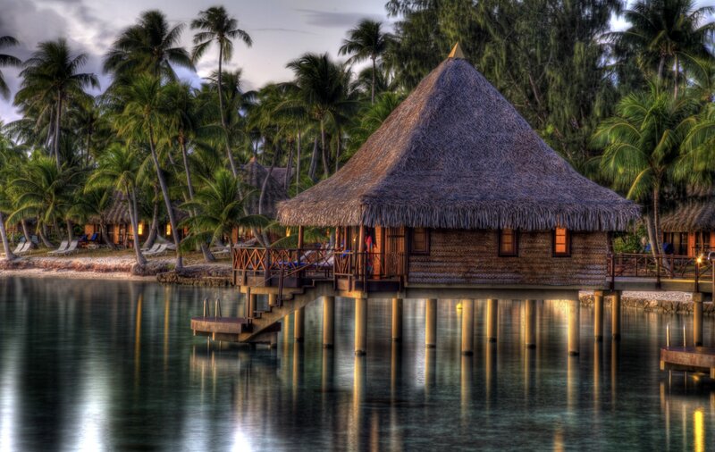 Tropical overwater bungalow at dusk