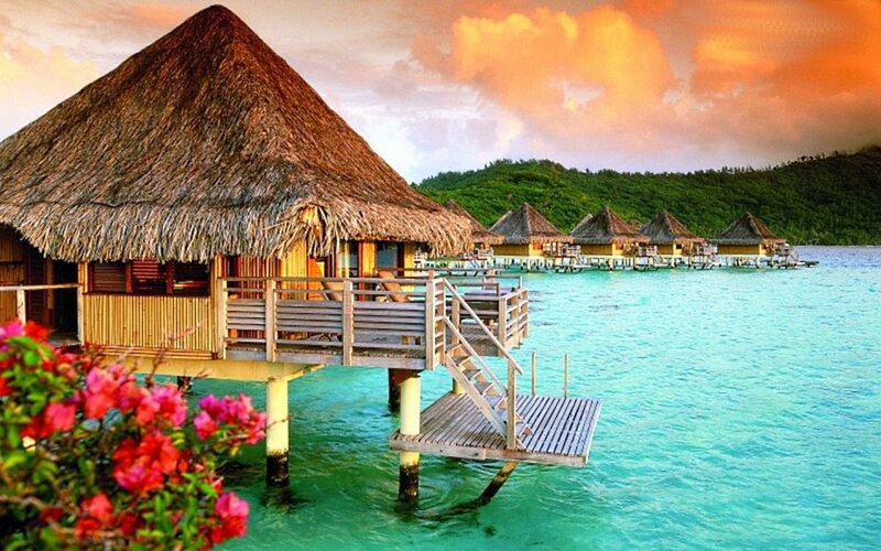 Tropical overwater bungalows at sunset