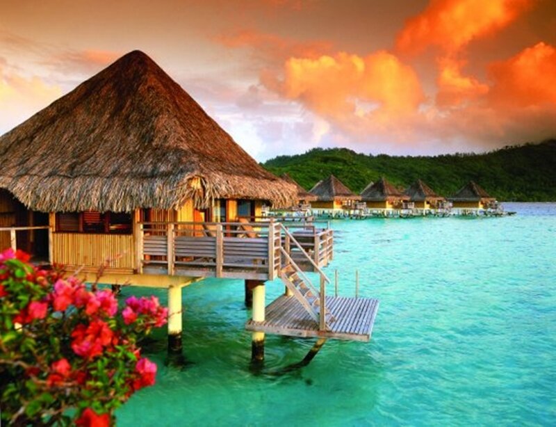 Tropical overwater bungalows at sunset