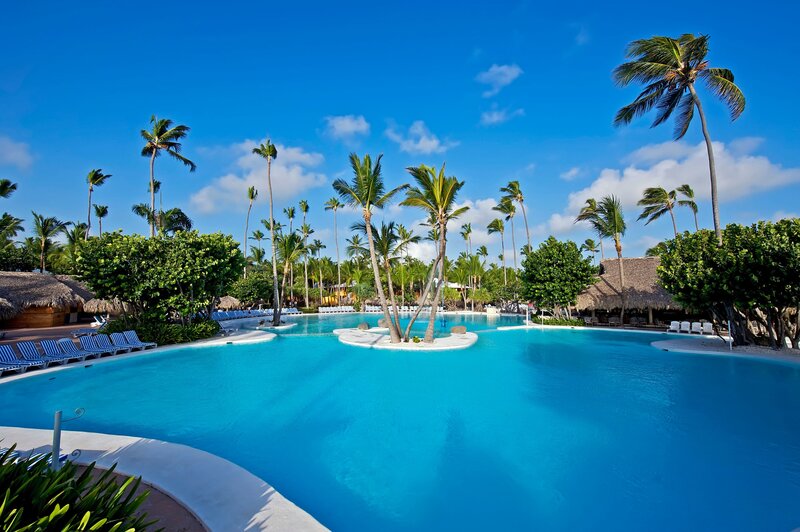 Tropical Resort Pool — Blue, Serene, Afternoon, Photograph, Palm Trees, Thatched Huts