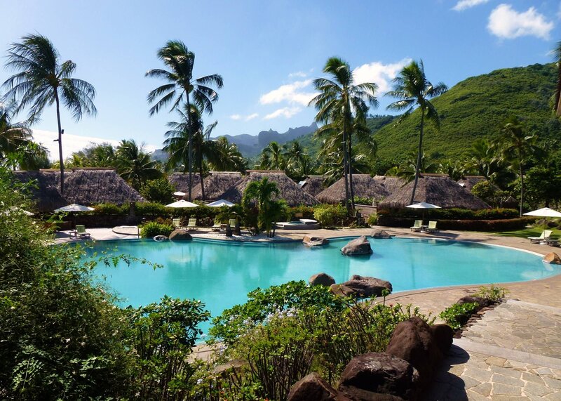 Tropical Resort Pool — Blue, Serene, Afternoon, Photograph, Palm Trees, Thatched Roofs