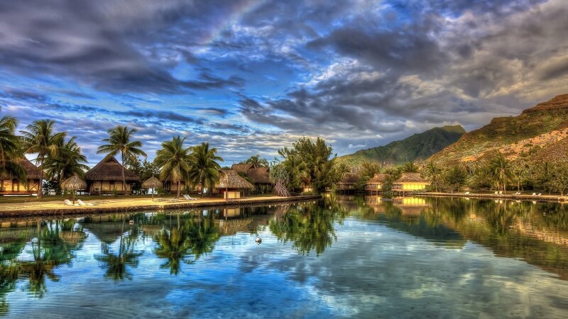 Tropical Resort Village — Blue, Dramatic, Sunset, Photograph, Palm Trees, Thatched Huts, Mountains