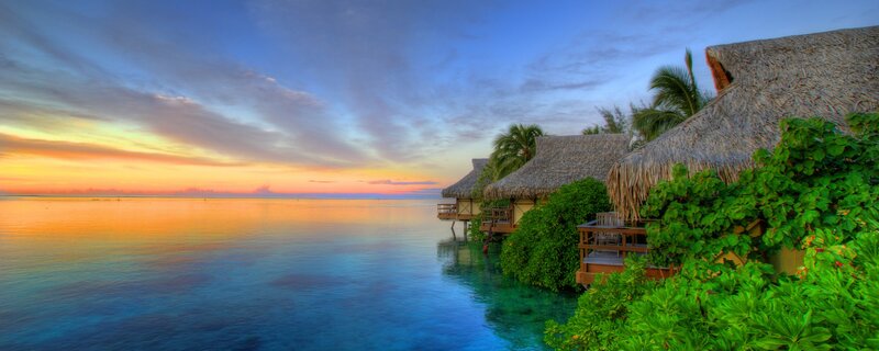tropical sunset over water villas