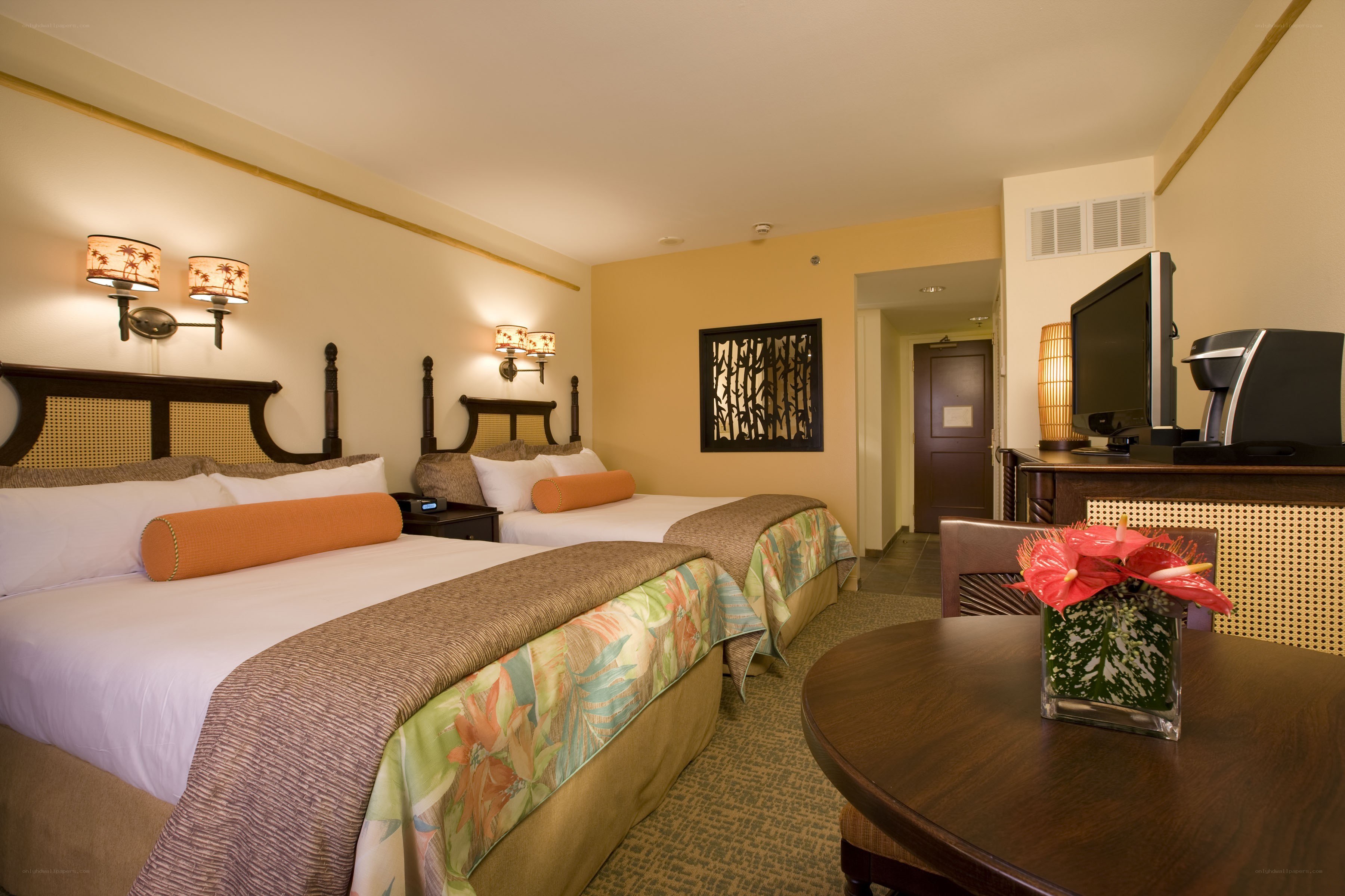 Tropical-themed hotel room with two beds
