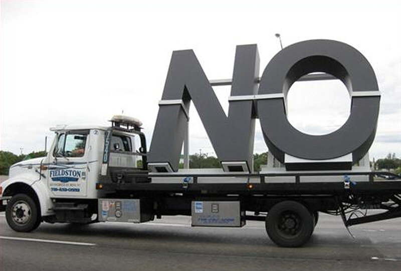 Truck carrying large NO sign