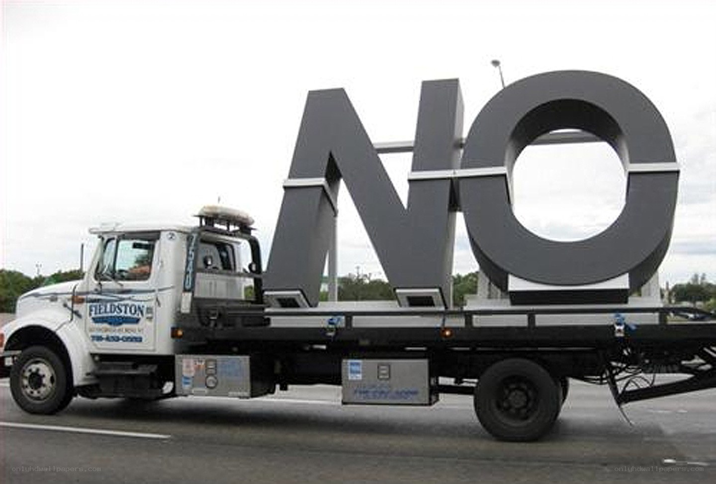 Truck carrying large NO sign