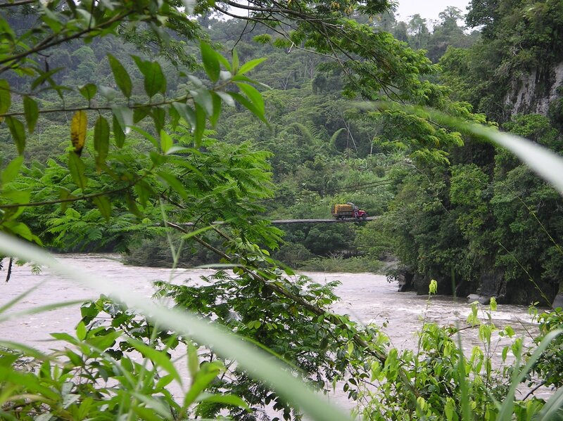Truck crossing river bridge