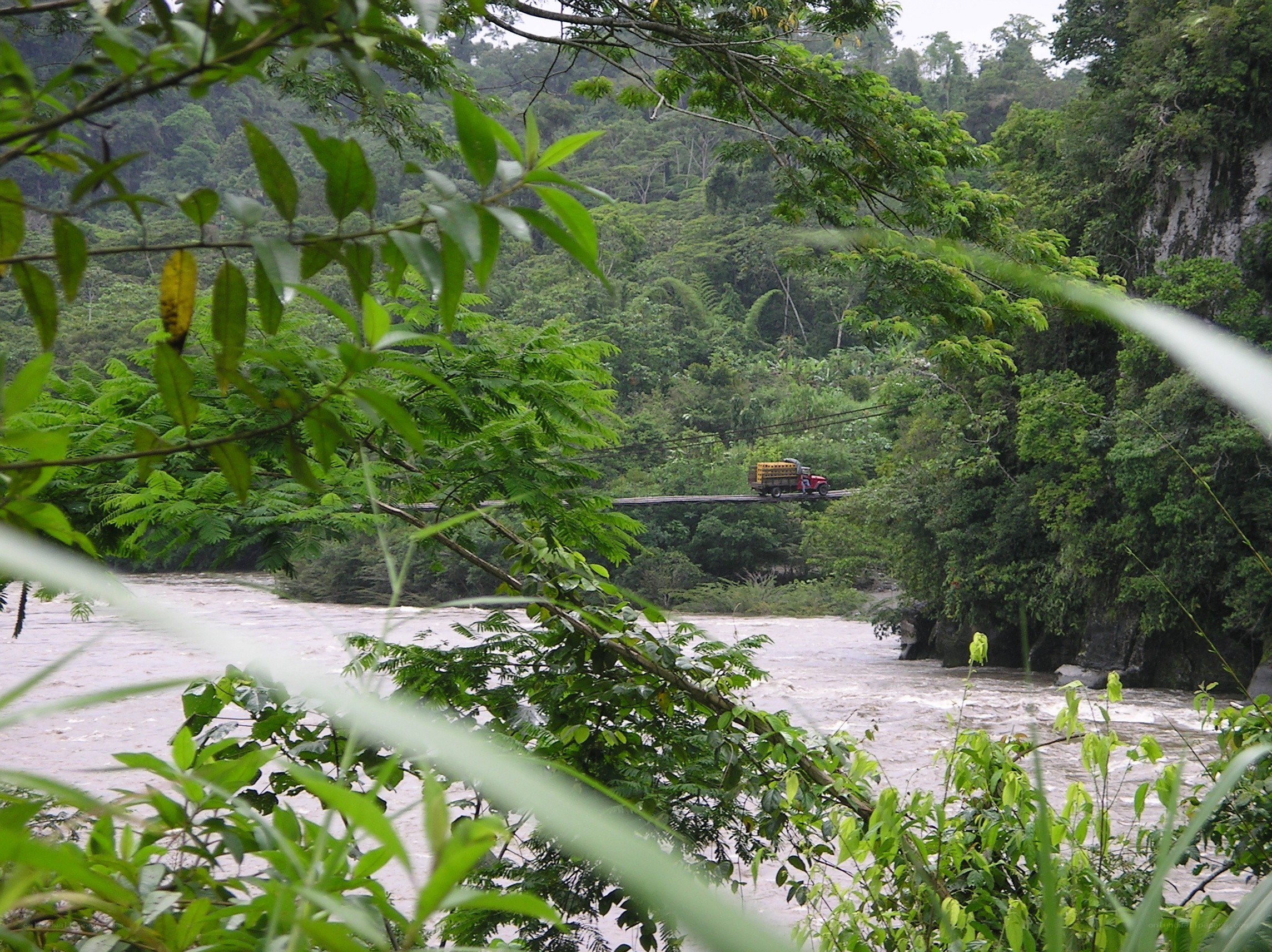 Truck crossing river bridge