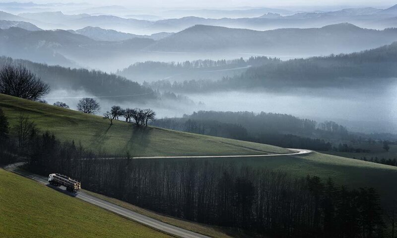 Truck on a winding road in fog
