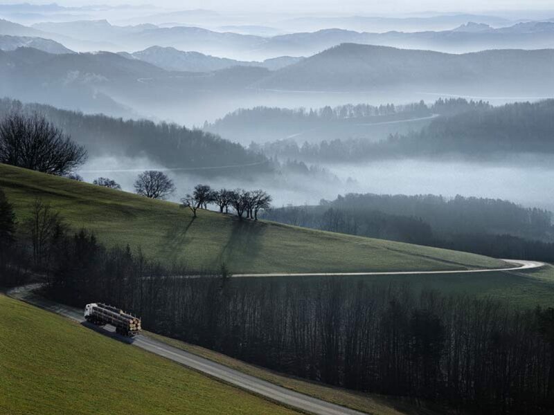 Truck on a winding road in foggy hills
