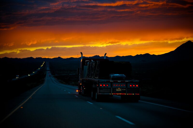 Truck on highway at sunset