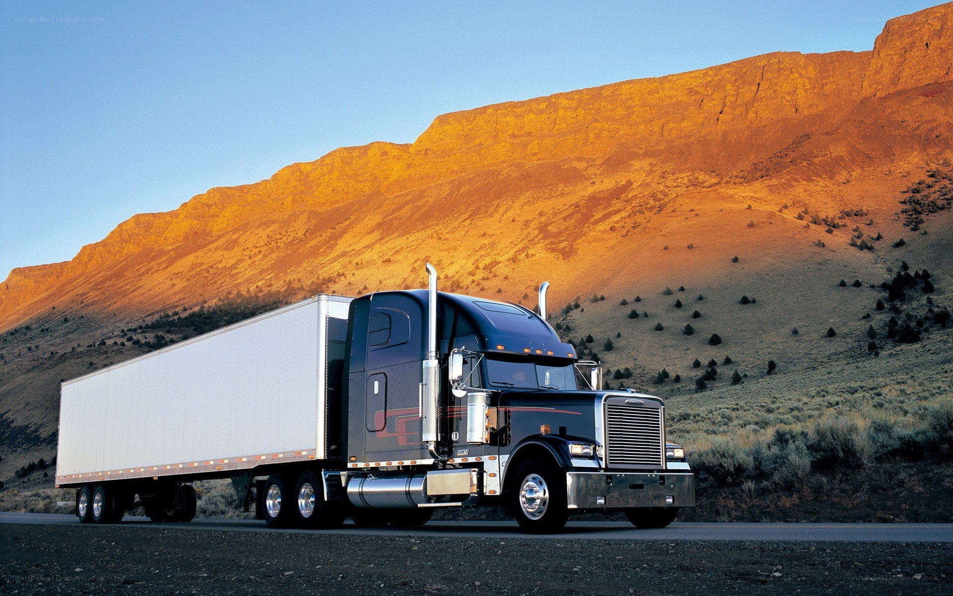 Truck on mountain road at sunset