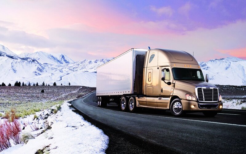 Truck on snowy mountain road