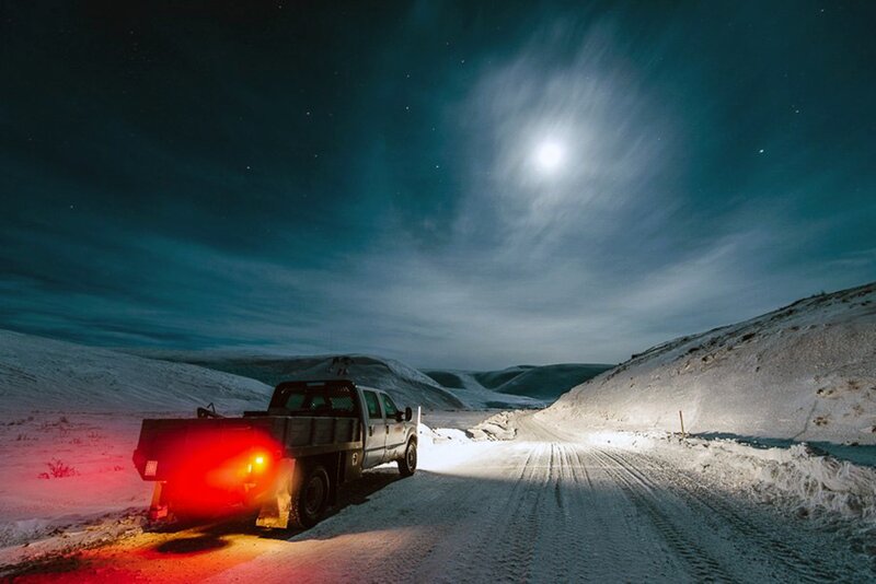 Truck on snowy road at night