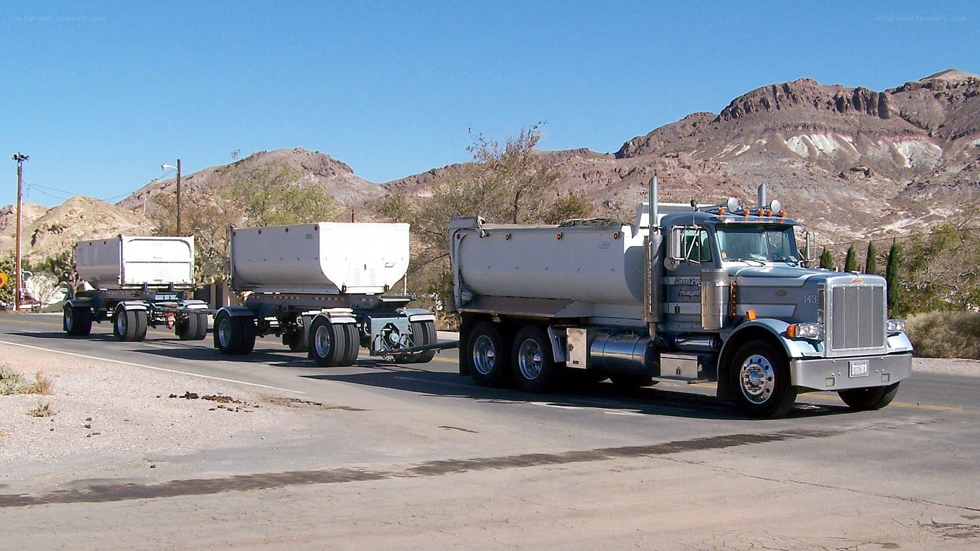 Truck with three trailers on road